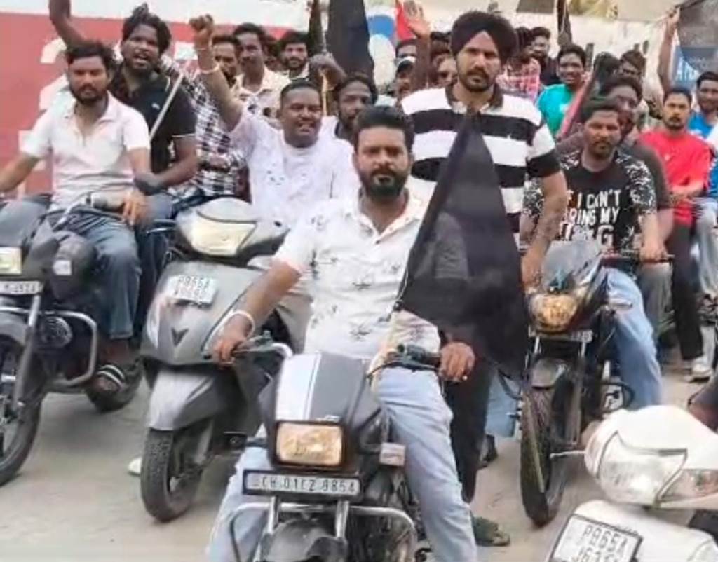 Motorcycle protest rally with black flags by sanitation workers in Kharar